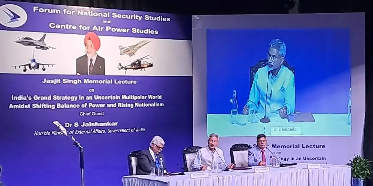 Dr S Jaishankar delivering the Jasjit Singh Memorial Lecture on India's grand strategy, shown on a large screen with the event backdrop and seated panellists